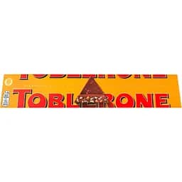 Шоколад Toblerone молочний з цукатами з апельсинової цедри, меленого імбиру і медово-мигдальною нугою 360 г